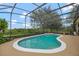 Gorgeous screened-in pool and spa with lush landscaping, offering a tranquil outdoor living space at 14231 Sonco Ave, Windermere, FL 34786