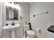 Charming powder room with pedestal sink, decorative mirror, and neutral decor at 14231 Sonco Ave, Windermere, FL 34786
