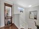 Elegant stairway with wood flooring, decorative mirror, and natural light from above at 14231 Sonco Ave, Windermere, FL 34786