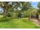 Well-manicured backyard with mature trees and lush greenery, offering a serene and private outdoor retreat at 1428 Lucky Pennie Way, Apopka, FL 32712