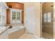 Bathroom features a tub, walk-in shower, and natural lighting at 1428 Lucky Pennie Way, Apopka, FL 32712