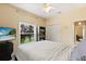 Bright bedroom featuring a ceiling fan, neutral walls, and a window view for a cozy and inviting atmosphere at 1428 Lucky Pennie Way, Apopka, FL 32712