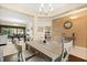 Open-concept layout with a modern dining area adjacent to a living space with a patio view and exercise equipment at 1428 Lucky Pennie Way, Apopka, FL 32712