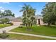 Inviting single-story home featuring a lush green lawn, beautiful landscaping, and a cozy two-car garage at 1428 Lucky Pennie Way, Apopka, FL 32712