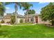 Charming single-story home with a well-maintained lawn, complemented by mature trees and landscaping at 1428 Lucky Pennie Way, Apopka, FL 32712