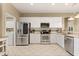 Bright kitchen features stainless steel appliances and white cabinetry at 1428 Lucky Pennie Way, Apopka, FL 32712