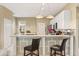 Stylish kitchen with white cabinets, sleek countertops, and convenient bar seating for casual dining at 1428 Lucky Pennie Way, Apopka, FL 32712