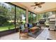 Covered lanai with outdoor seating overlooking the lush backyard, perfect for relaxation and entertaining guests at 1428 Lucky Pennie Way, Apopka, FL 32712