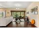 Cozy living area with exercise equipment, patio access, neutral tones, and ample natural light at 1428 Lucky Pennie Way, Apopka, FL 32712