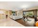Spacious living room with a fireplace, built-in shelving, and a seamless transition to the outdoor patio area at 1428 Lucky Pennie Way, Apopka, FL 32712