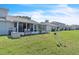 Backyard with patio, seating, and well-maintained lawn at 14650 Laguna Beach Cir, Orlando, FL 32824