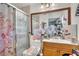 Bathroom features a shower with glass doors, vanity with framed mirror, and decorated toilet at 14650 Laguna Beach Cir, Orlando, FL 32824