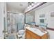 Bathroom features a shower and tub combo with a framed mirror and ample counter space at 14650 Laguna Beach Cir, Orlando, FL 32824