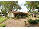 Expansive backyard with mature trees, lush landscaping, and a screened lanai at 1575 N Ridge Lake Cir, Longwood, FL 32750