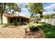 Picturesque backyard featuring a manicured lawn, mature plantings, and privacy fencing at 1575 N Ridge Lake Cir, Longwood, FL 32750