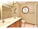 Bathroom featuring double sinks, floral stained glass, and shower, combining functionality with design at 1575 N Ridge Lake Cir, Longwood, FL 32750