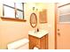 This bathroom features a mirror, vanity, toilet and window at 1575 N Ridge Lake Cir, Longwood, FL 32750