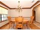 Charming dining area with a chandelier, wood table, and decorative molding, perfect for Gathering gatherings at 1575 N Ridge Lake Cir, Longwood, FL 32750