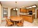 The dining room features a wood table with chairs, with kitchen in the background at 1575 N Ridge Lake Cir, Longwood, FL 32750
