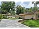 Well-maintained home with a long driveway, lush lawn, manicured flower beds and attached garage at 1575 N Ridge Lake Cir, Longwood, FL 32750