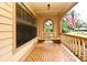 Inviting front porch with a swing and views of the landscaped yard at 1575 N Ridge Lake Cir, Longwood, FL 32750