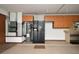 Functional garage equipped with overhead storage, refrigerator, and a water heater at 1575 N Ridge Lake Cir, Longwood, FL 32750