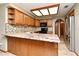 Open kitchen featuring custom cabinets, mosaic backsplash, and granite countertops at 1575 N Ridge Lake Cir, Longwood, FL 32750