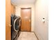 Efficient laundry room with modern washer and dryer, tile floors, and convenient access to utilities at 1575 N Ridge Lake Cir, Longwood, FL 32750