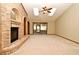Sun-lit living room featuring a brick fireplace, and sliding door access to the patio at 1575 N Ridge Lake Cir, Longwood, FL 32750
