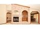 Cozy living room featuring a brick fireplace and built-in shelving at 1575 N Ridge Lake Cir, Longwood, FL 32750