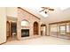 Spacious living room with vaulted ceilings, brick fireplace, and access to the patio at 1575 N Ridge Lake Cir, Longwood, FL 32750