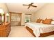 Cozy main bedroom with ceiling fan, sliding glass door, dresser, and comfortable neutral decor at 1575 N Ridge Lake Cir, Longwood, FL 32750