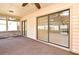 Relaxing covered patio featuring neutral tones, brick accents, and sliding glass doors to the yard at 1575 N Ridge Lake Cir, Longwood, FL 32750