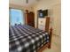 View of bedroom with a wooden bed frame, fan, and dresser near a window at 16922 Se 81St Charlesfort Ave, The Villages, FL 32162