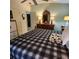 Spacious bedroom featuring a ceiling fan, a bed with a patterned quilt, and dresser with mirror at 16922 Se 81St Charlesfort Ave, The Villages, FL 32162