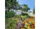 Entrance to Merry Oak Villas featuring colorful flower beds and lush landscaping surrounding the community sign at 16922 Se 81St Charlesfort Ave, The Villages, FL 32162