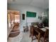 Charming dining room next to a sunroom featuring a wooden table set for four, perfect for Gathering meals at 16922 Se 81St Charlesfort Ave, The Villages, FL 32162