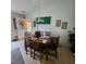 Well-lit dining area with a wooden table set for four, adjacent to sunroom access at 16922 Se 81St Charlesfort Ave, The Villages, FL 32162