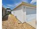 Side of home featuring low maintenance landscaping, vinyl siding, and attached garage at 16922 Se 81St Charlesfort Ave, The Villages, FL 32162