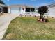 Inviting home exterior with vibrant landscaping, white picket fence, and a cozy front lawn at 16922 Se 81St Charlesfort Ave, The Villages, FL 32162