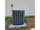 Close-up of a Trane HVAC unit, set on a concrete slab, with a beige siding as backdrop at 16922 Se 81St Charlesfort Ave, The Villages, FL 32162