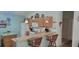 Efficient kitchen with wooden cabinets, breakfast bar, and modern appliances, perfect for meal preparation at 16922 Se 81St Charlesfort Ave, The Villages, FL 32162