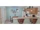 Functional kitchen with wooden cabinets, breakfast bar, and efficient layout for cooking and entertaining at 16922 Se 81St Charlesfort Ave, The Villages, FL 32162