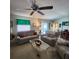 Comfortable living room with ceiling fan and a view to the dining room at 16922 Se 81St Charlesfort Ave, The Villages, FL 32162
