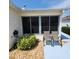 Enclosed patio area offering outdoor seating and privacy, complemented by well-maintained landscaping at 16922 Se 81St Charlesfort Ave, The Villages, FL 32162
