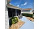 Cozy screened-in patio featuring seating, surrounded by lush landscaping and rock ground cover at 16922 Se 81St Charlesfort Ave, The Villages, FL 32162