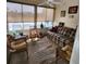 Cozy sunroom featuring a plaid couch, wicker chairs, and ample natural light for a comfortable living space at 16922 Se 81St Charlesfort Ave, The Villages, FL 32162