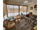Inviting sunroom with ample natural light, featuring a plaid couch and wicker chairs at 16922 Se 81St Charlesfort Ave, The Villages, FL 32162
