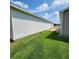 A well-maintained yard showcases the property's white siding and lush green grass at 16922 Se 81St Charlesfort Ave, The Villages, FL 32162