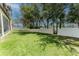 Expansive backyard with green lawn and a pristine white fence overlooking the lake at 1778 Waterside Oaks Dr, Orange City, FL 32763